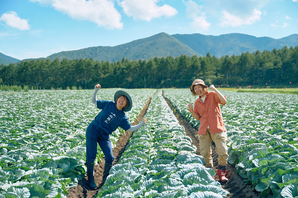 キャベツ畑で笑う関根さんとガイドの松本さん