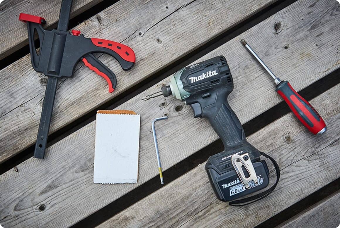 キャンプサイトに道具を展開し、DIYの仕上げ作業に取り掛かります