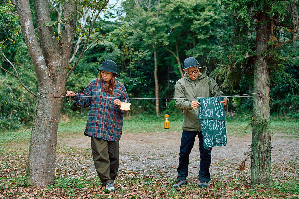 木にロープをくくりつけて物を干すこいしゆうかと寒川一さんの画像