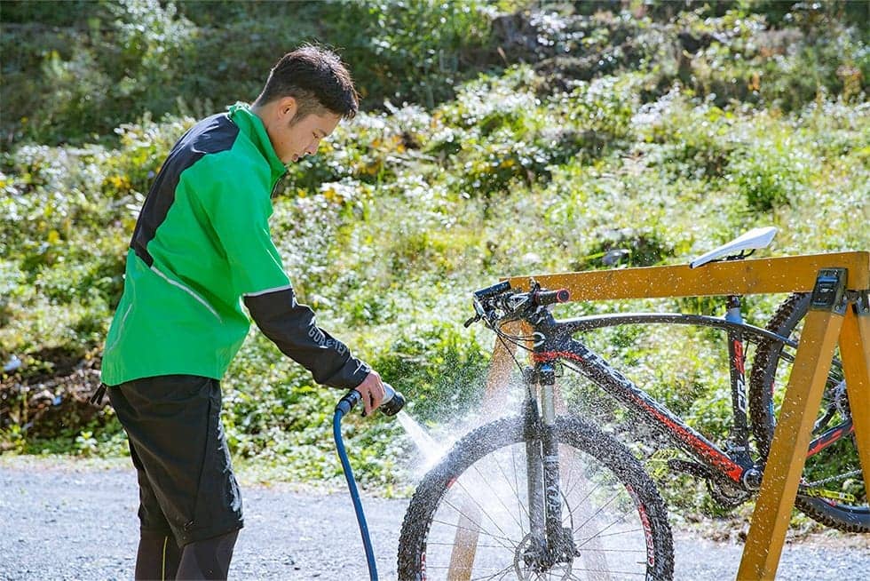 坂を下っているときに感じた「スリル」の余韻に浸りながら、タイヤに付いた泥を落とす