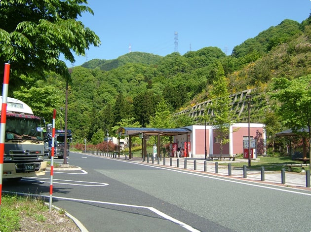 トイレに向かって右手。芝生のエリアと屋根の付いたベンチがあります。