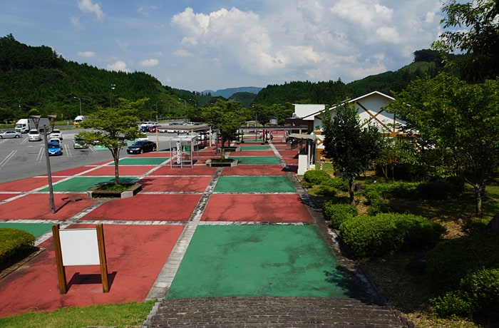 高台から見たサービスエリア全景と、周りにそびえ立つ山々です。