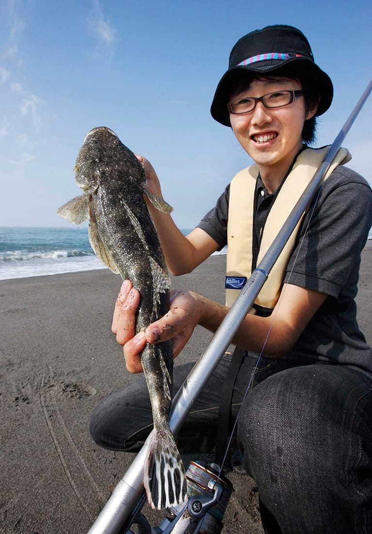 生まれて初めて釣ったマゴチ。あまりの嬉しさに顔がこわばってしまい、あんまり嬉しそうに見えないオチアイ君